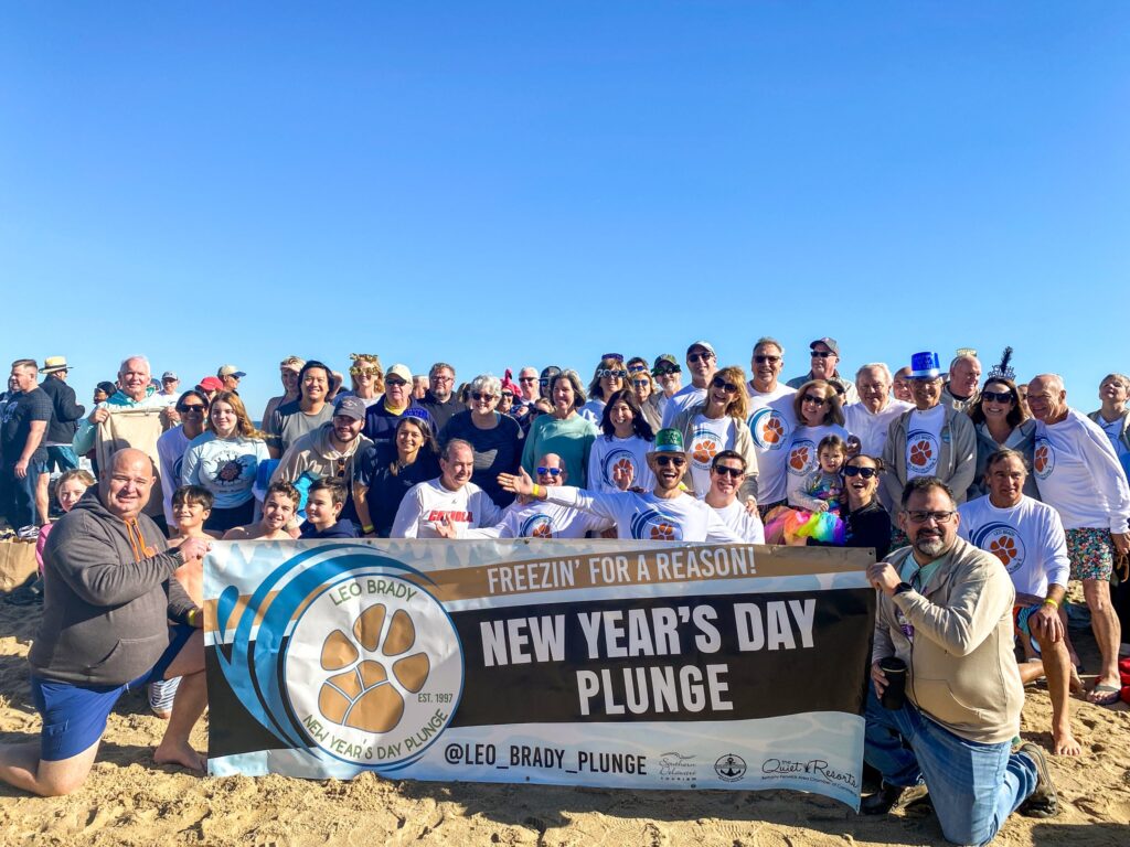 a group of people holding a new year's day plunge sign