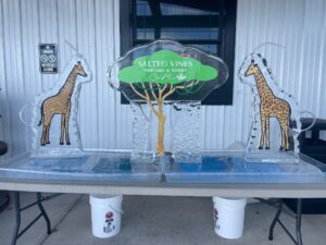 two giraffes and a tree on a table