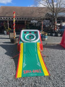 an inflatable ball game set up on gravel