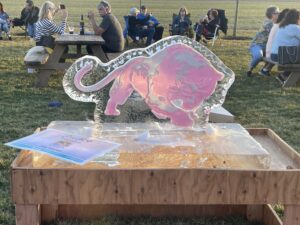 a pink elephant sculpture sitting on top of a wooden table