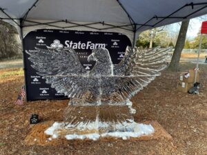 a glass sculpture of an eagle in front of a state farm sign