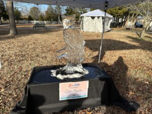 an owl statue is on display under a tent