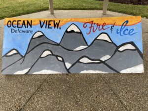 a sign with mountains painted on it that says ocean view, fire and ice