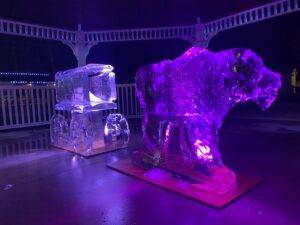 two ice sculptures are lit up with purple lights