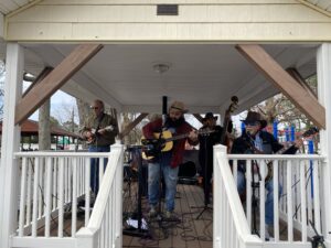 a group of people playing music on a porch