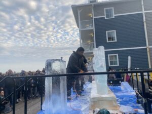 a man standing on top of an ice sculpture