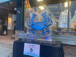 a blue crab ice sculpture in front of a store