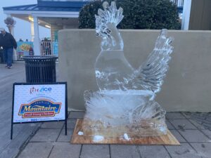 an ice sculpture of a chicken on a wooden board