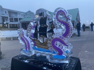 an ice sculpture of a boat in front of a building