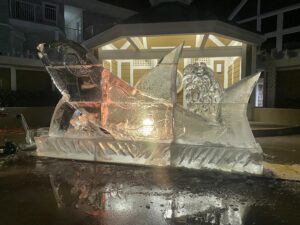 a large ice sculpture sitting on top of a puddle of water