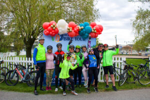 a group of people standing in front of a sign