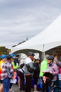 a group of people standing next to each other near a tent