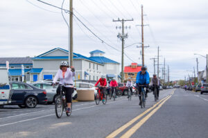 a group of people riding bikes down a street