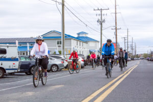 a group of people riding bikes down a street