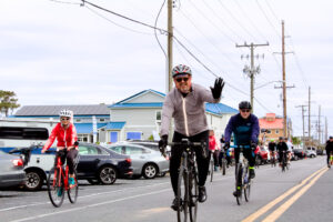 a group of people riding bikes down a street