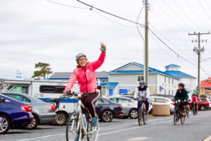 a group of people riding bikes down a street