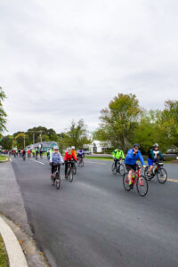 a group of people riding bikes down a street