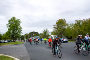 a group of people riding bikes down a street