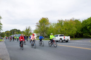 a group of people riding bikes down a street