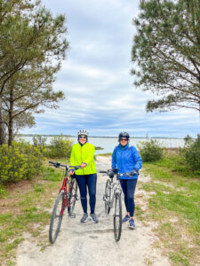 two people standing next to each other with bikes