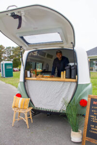 a man standing in the back of a camper van