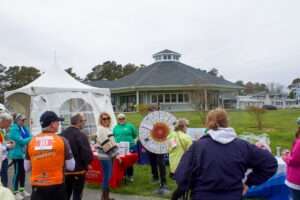 a group of people standing in front of a white tent