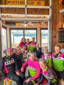 a group of women in wetsuits posing for a photo