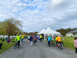 a group of people walking down a road next to tents