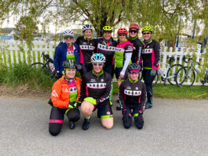 a group of people in cycling gear posing for a photo