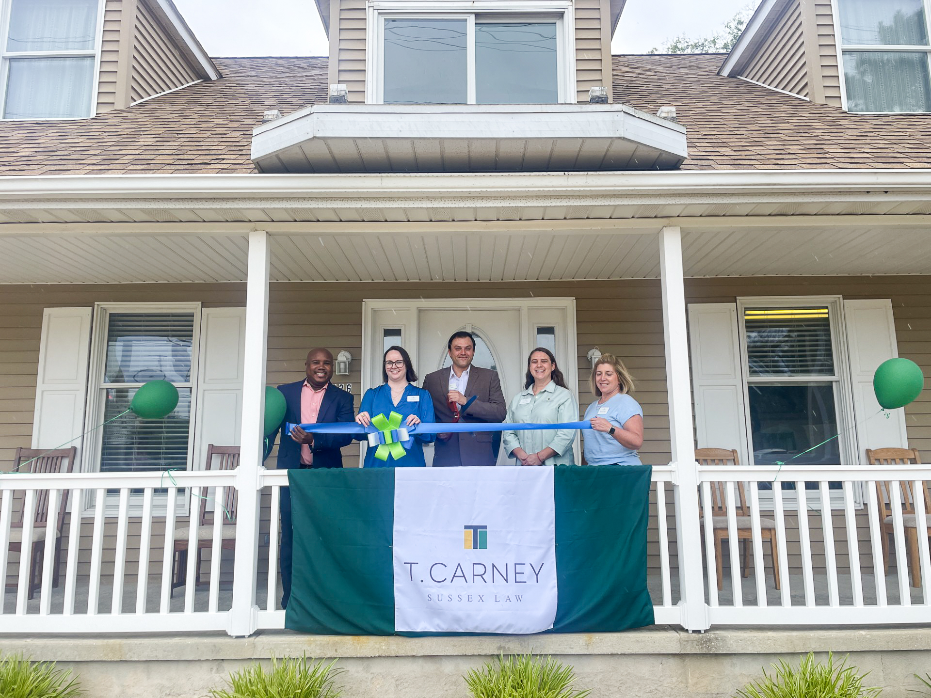 a group of people standing in front of a house